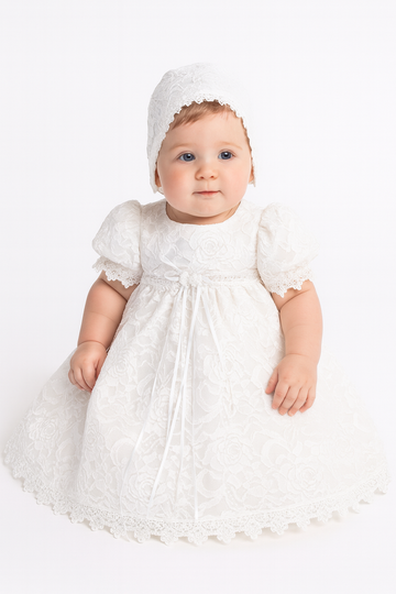 Baby in a white baptism dress and bonnet