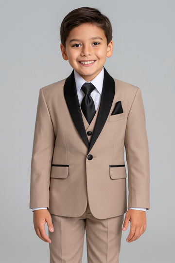 Young boy wearing a beige suit with black lapels and tie