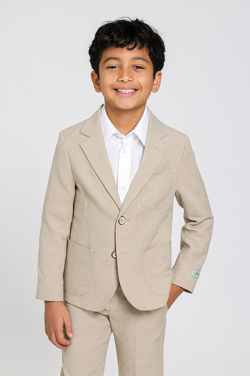 Young boy wearing a beige linen suit with a white shirt