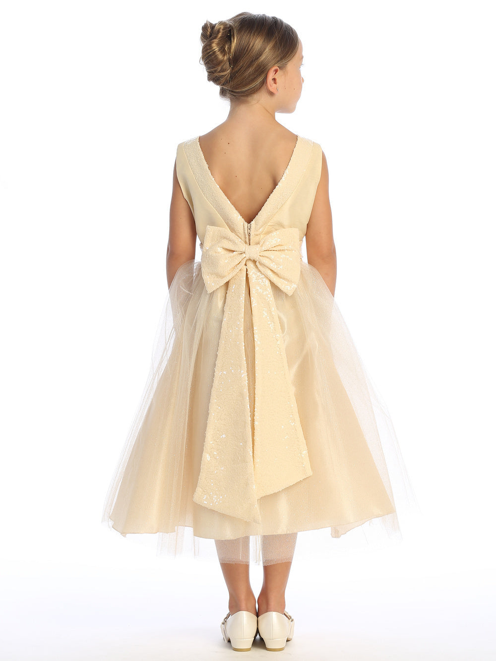 Champagne-hued shantung and tulle dress twinkles with sequins on a flower girl.