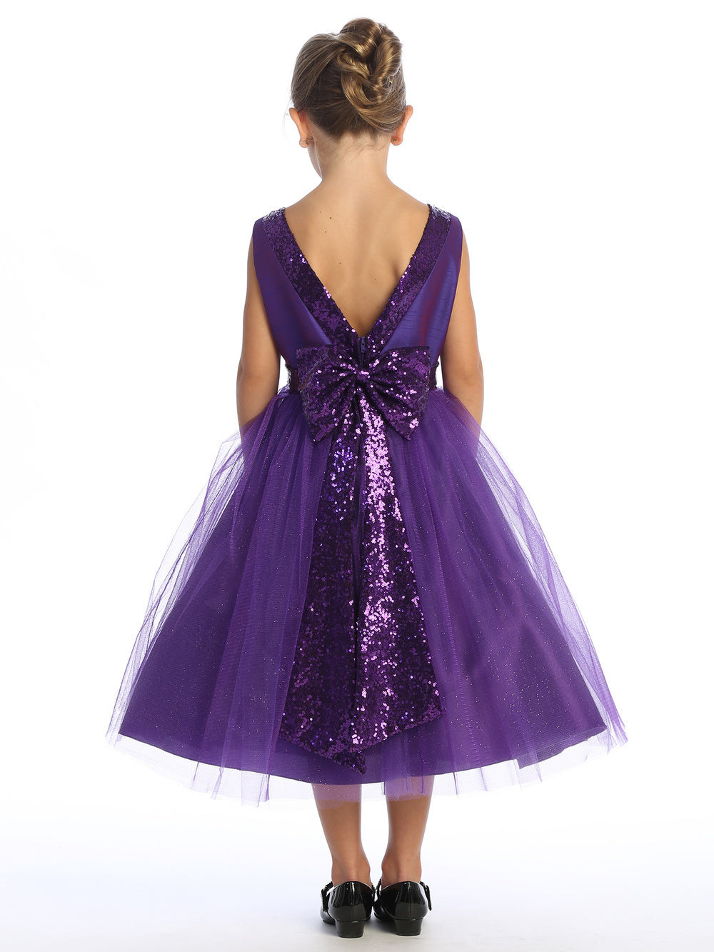 Purple shantung dress, adorned with sparkle tulle and sequins, crowns a radiant flower girl.