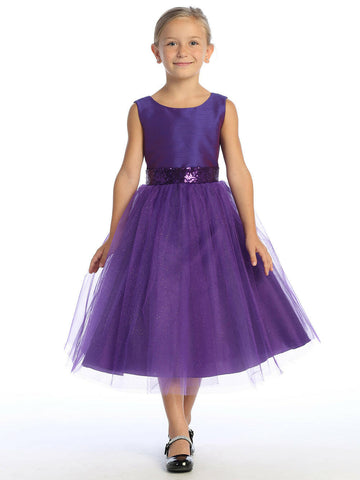 Elegant Purple Flower Girl Dress with shantung bodice and sparkle tulle skirt, worn by a young girl. Features sequin waistband and tea length design.