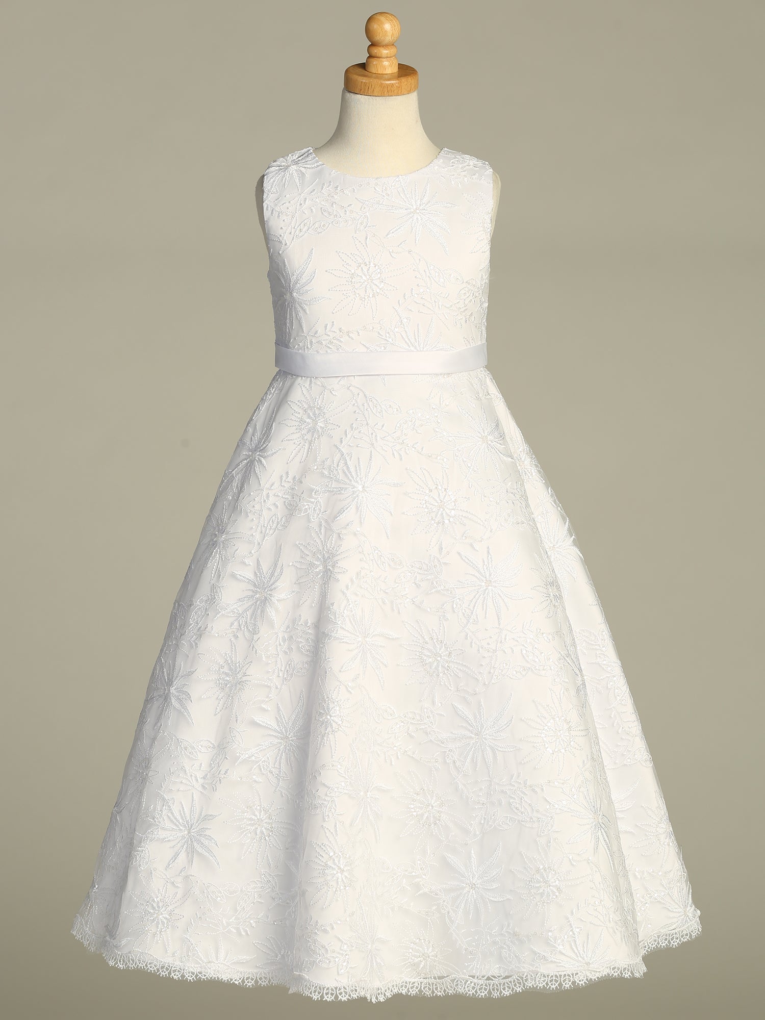 Back view of the First Communion Dress showing the zipper and tie-back tulle sash closure.