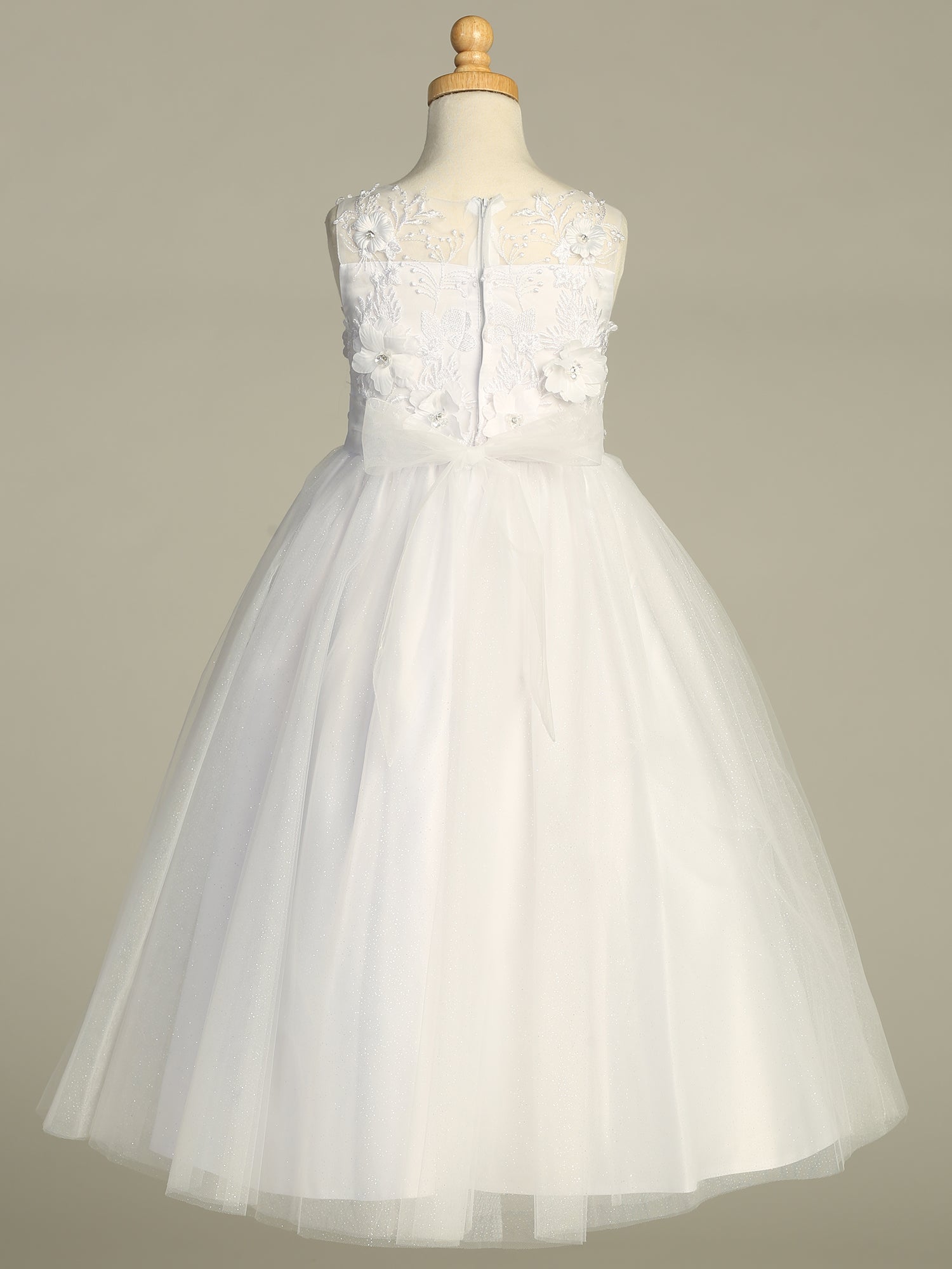 Close-up view of the embroidered tulle skirt adorned with 3D flowers on the First Communion Dress.