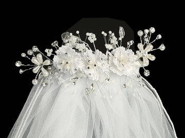 Close-up of 24" Communion veil with corded flowers, pearls, and rhinestones on a decorative headpiece. Ideal for girls' religious ceremonies.