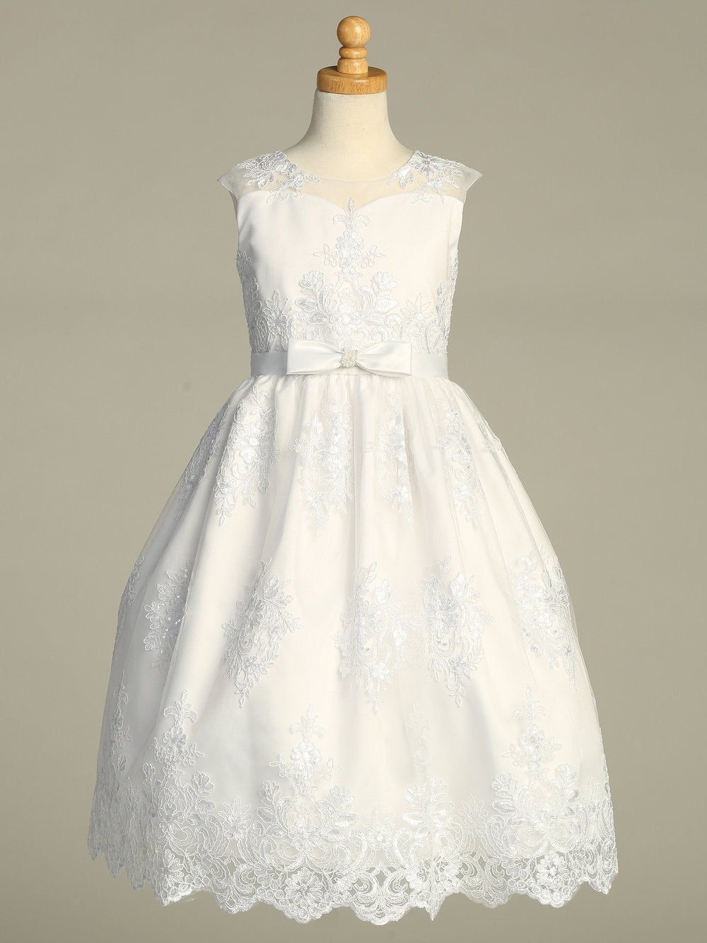 A full-length view of the First Communion Dress showing the elegant silhouette and corded embroidered tulle with sequins.