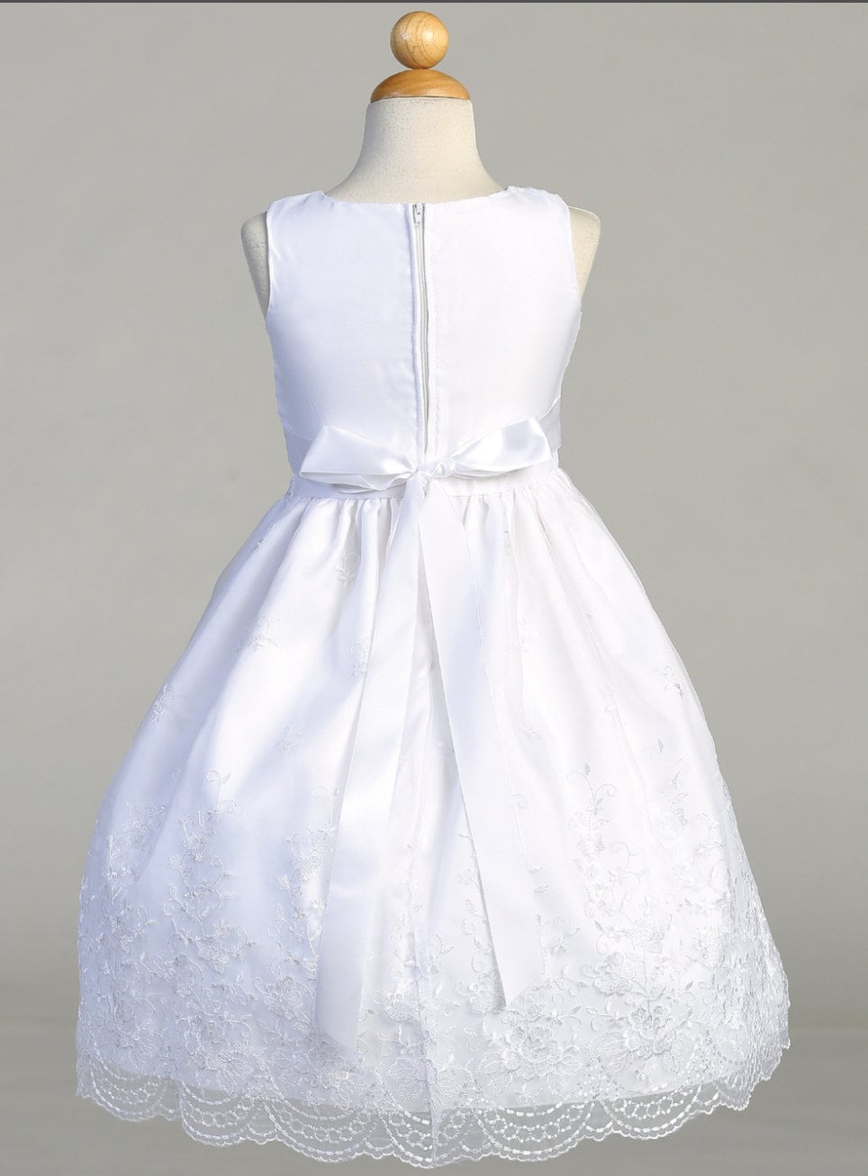 Back view of the First Communion Dress showing the zip fastening and bow tie.