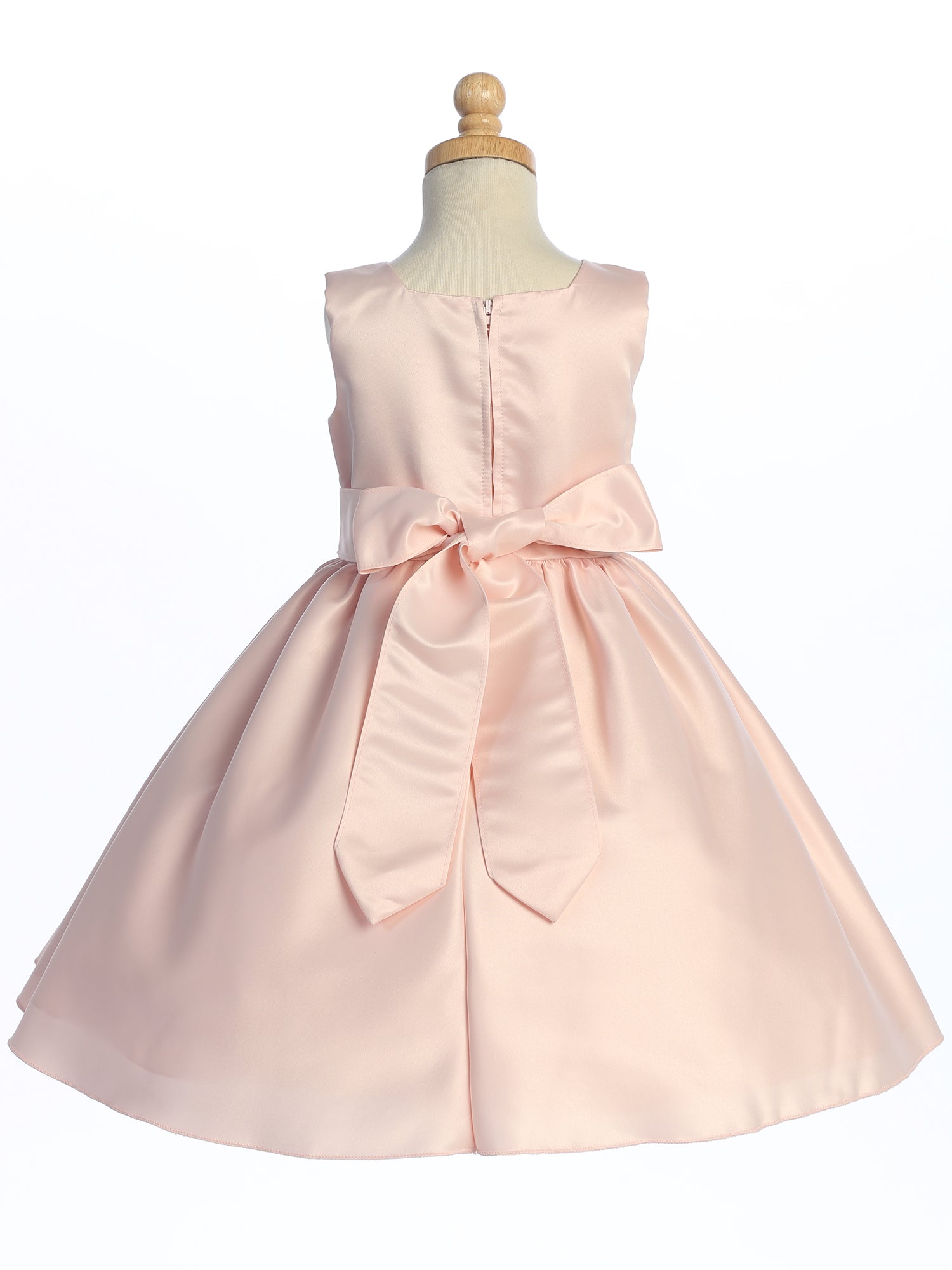 A satin dress from the U.S.A. adorning a flower girl, pure elegance embodied.