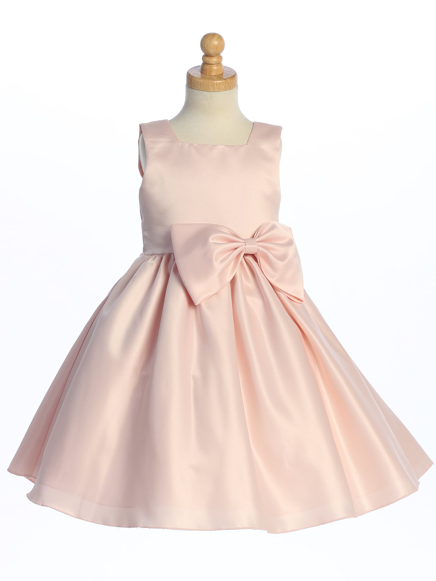 Flower girl glows in a satin dress, a celebration of U.S.A. craftsmanship.