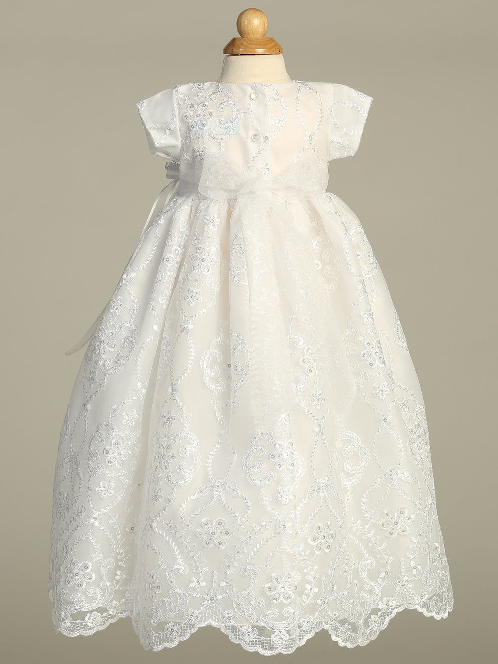 White lace bpatism gown on a mannequin 