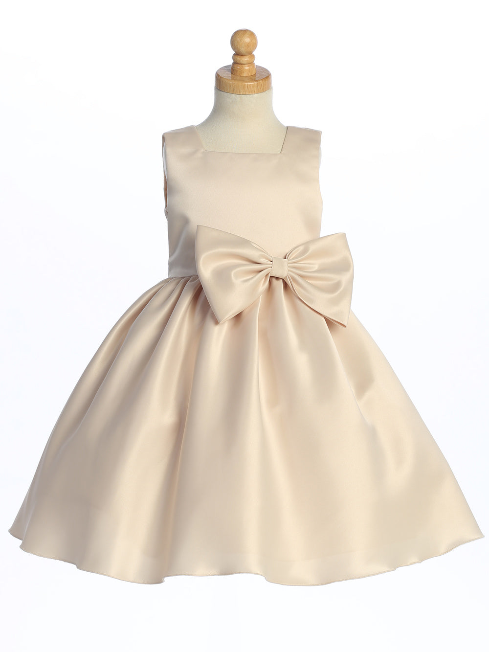 A U.S.A. made satin dress, its shine mirroring a flower girl's joy.