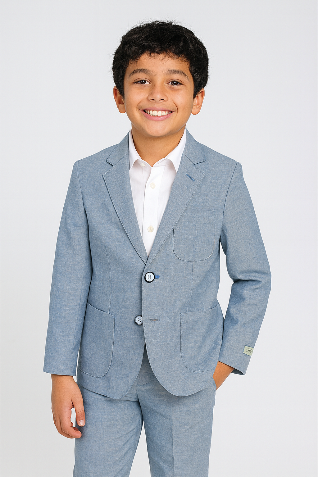Young boy wearing a light blue linen suit with a white shirt