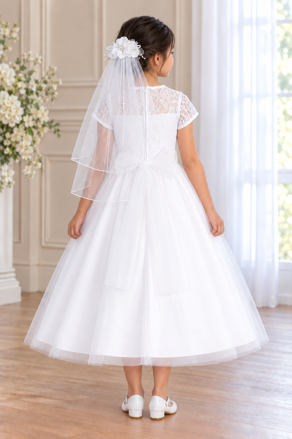 Style 190 white Communion dress back on a child model with Mia shoes and T-310 floral comb veil; accessories sold separately.