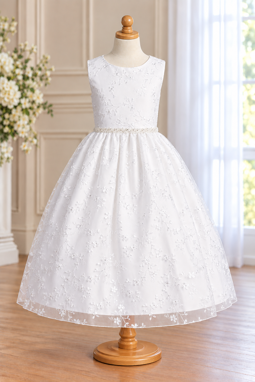 Style 201 white Communion dress front on a mannequin, showing the round neckline, floral vine embroidered tulle, beaded waist and straight tea-length hem.