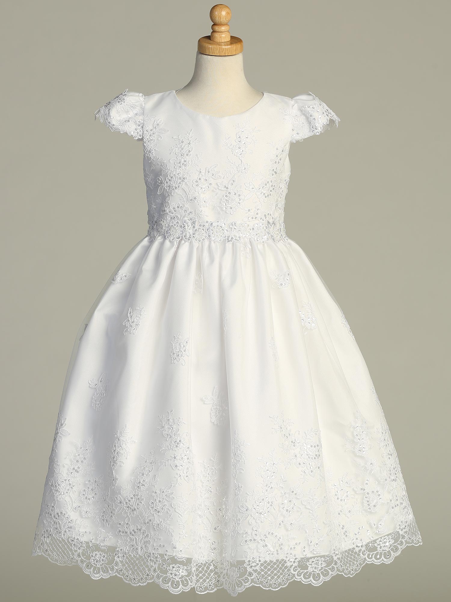 Girls' White First Communion Dress – Embroidered Tulle with floral lace and sequins, displayed on mannequin with cap sleeves and scalloped hem.