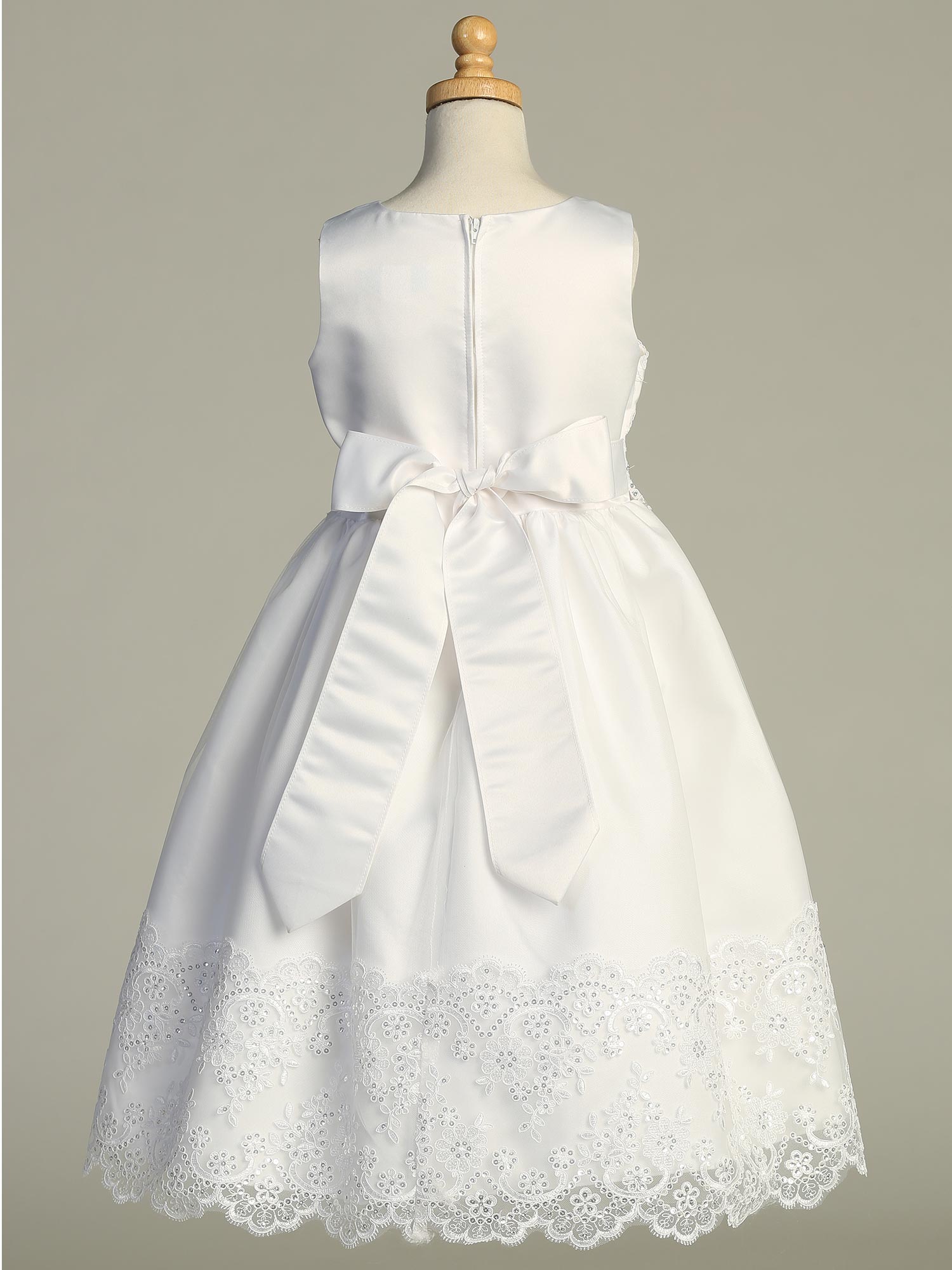 Back view of Girls First Communion Dress with satin bow and embroidered tulle hem. Elegant tea-length style made in the USA.