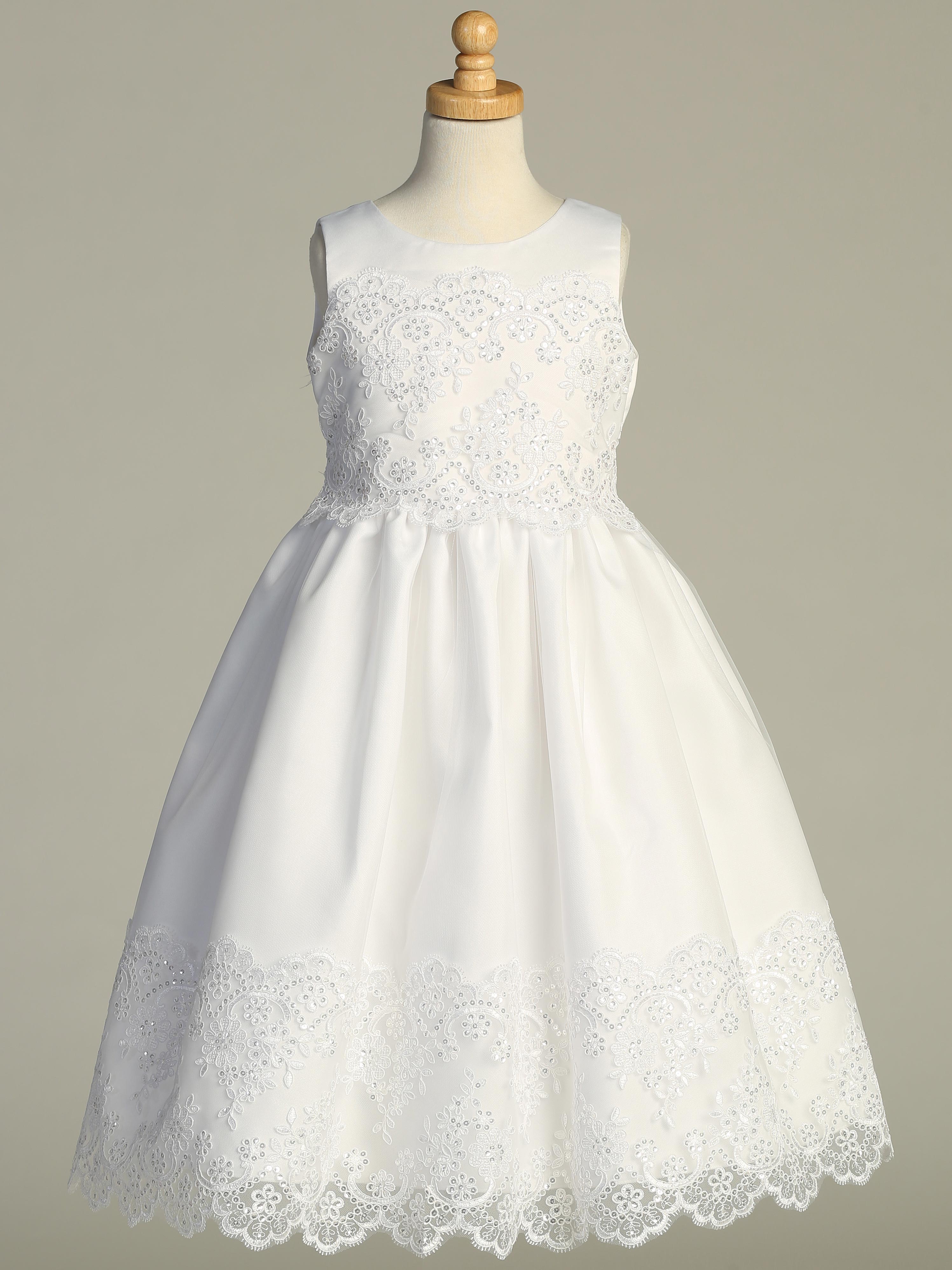 White Girls First Communion Dress on mannequin featuring corded embroidered tulle, sequins, and satin bodice. Tea-length design.