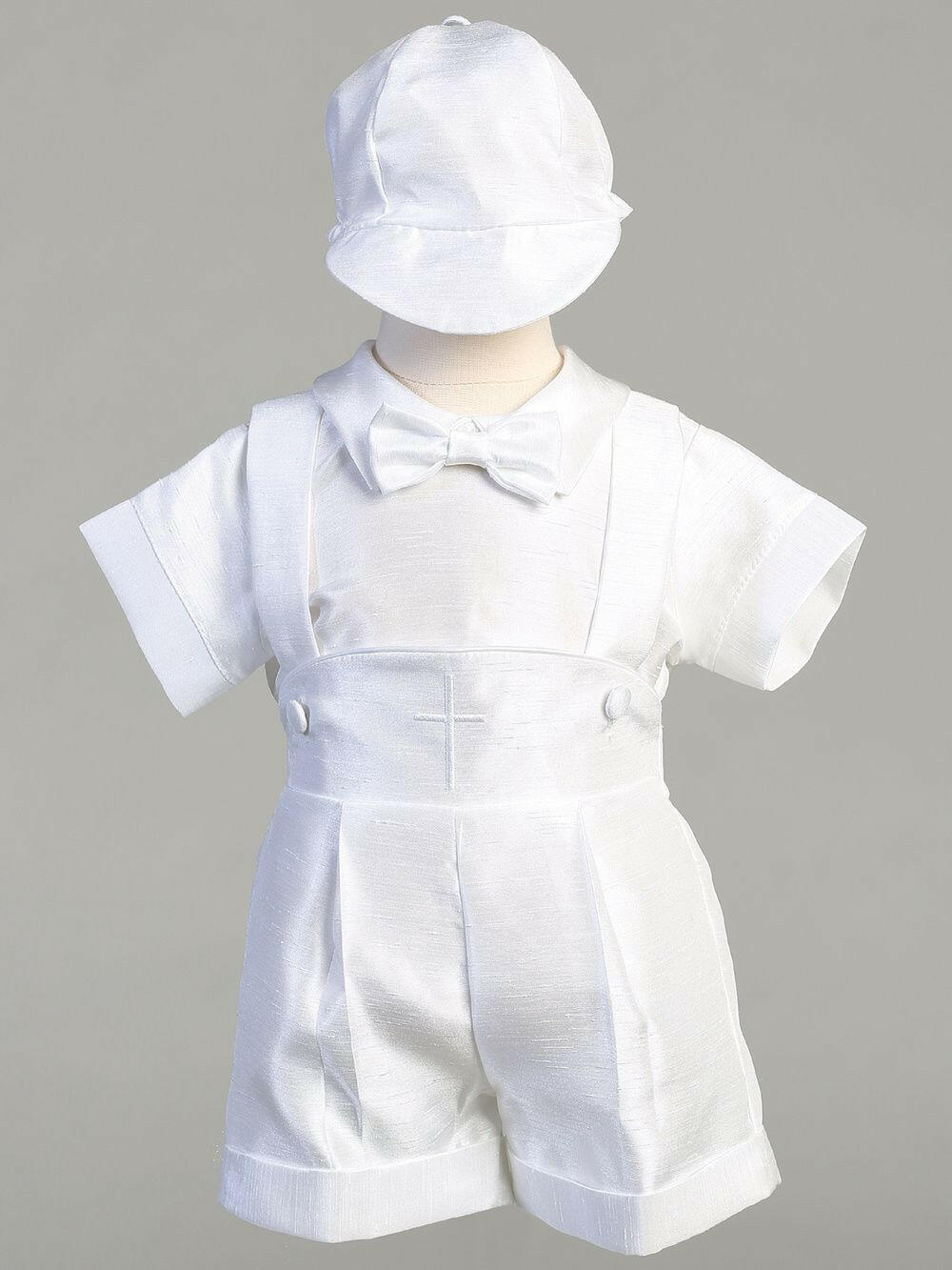 Maverick Baby Boys Outfit for Baptism and Christening in white with bow tie, cap, and pleated shorts. Elegant ceremonial clothing for infants.