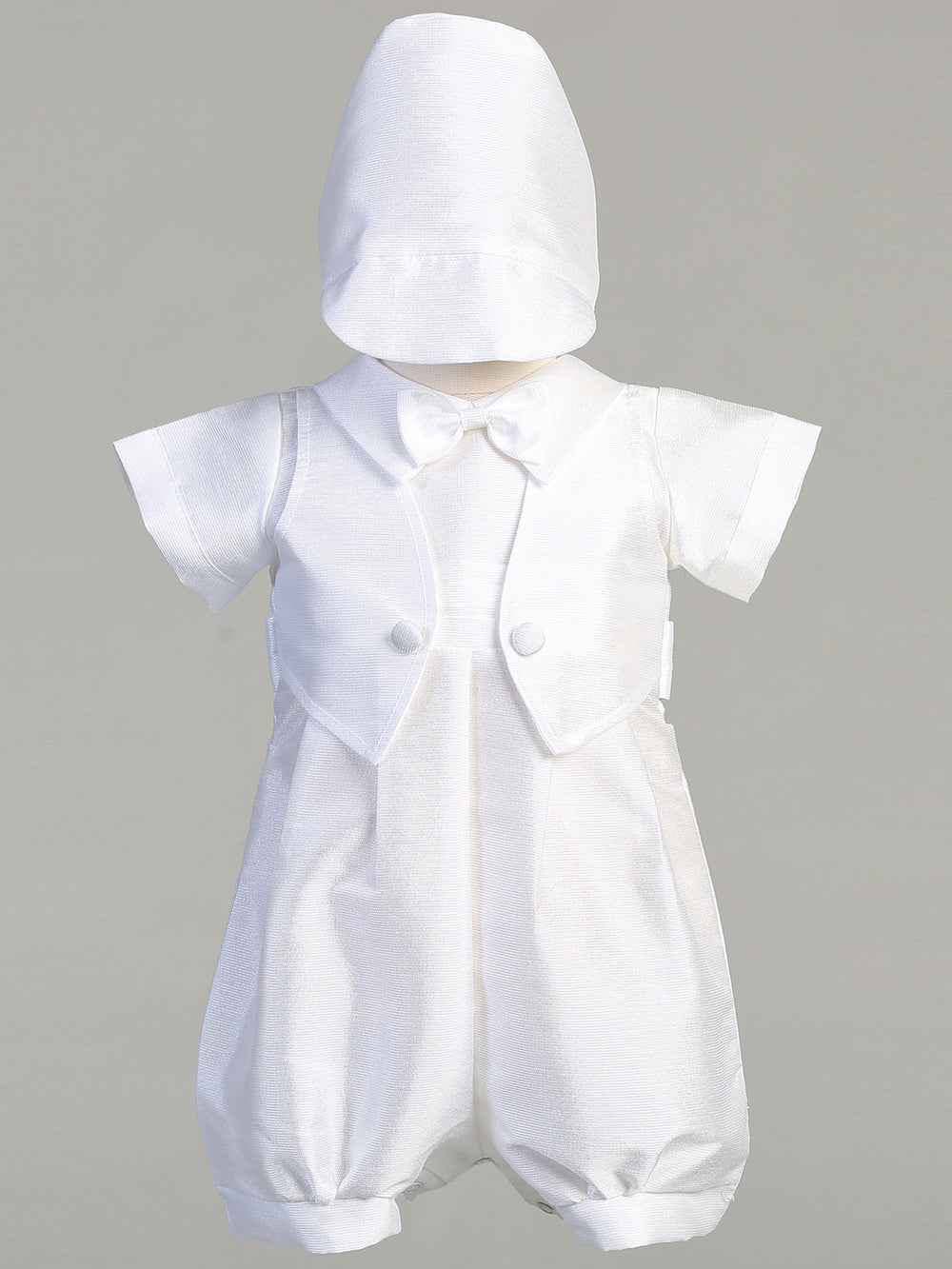 Boys Baptism Romper in white poly bengaline with vest, bowtie, and matching hat, ideal for christenings and special occasions.