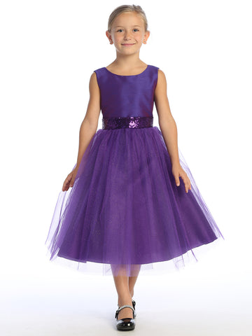 Flower girl captivates in a purple shantung dress, sequins glinting in the tulle.
