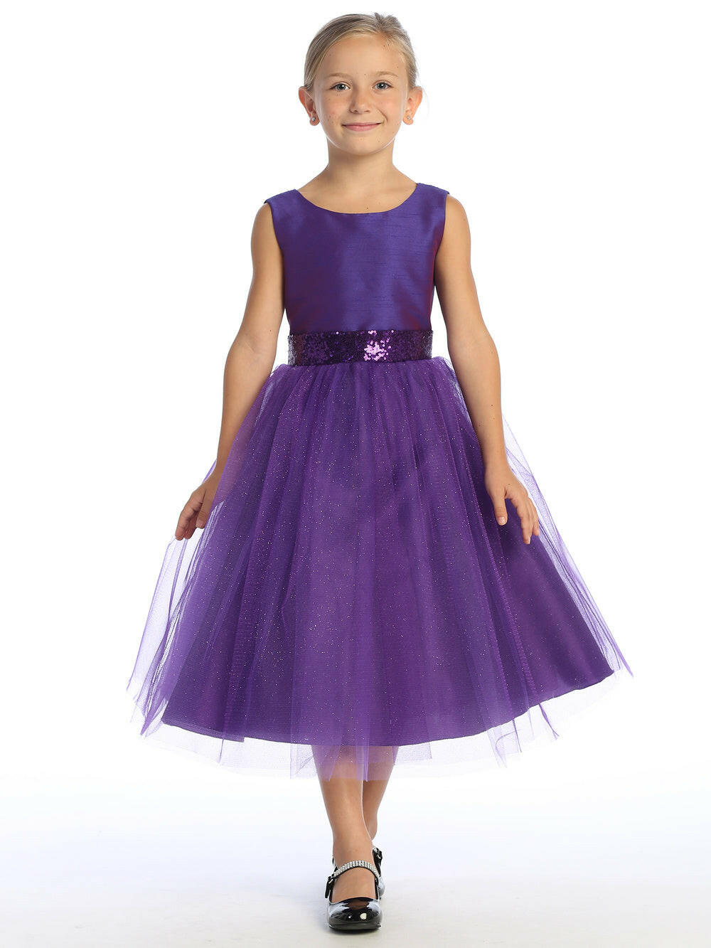 Elegant Purple Flower Girl Dress with shantung bodice and sparkle tulle skirt, worn by a young girl. Features sequin waistband and tea length design.