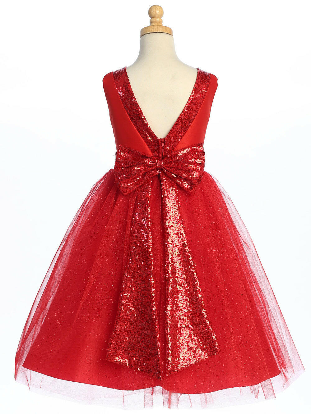 Back of red flower girl dress on mannequin featuring deep V-cut and large sequin bow. Sparkle tulle and tea-length design ideal for weddings and formal events.