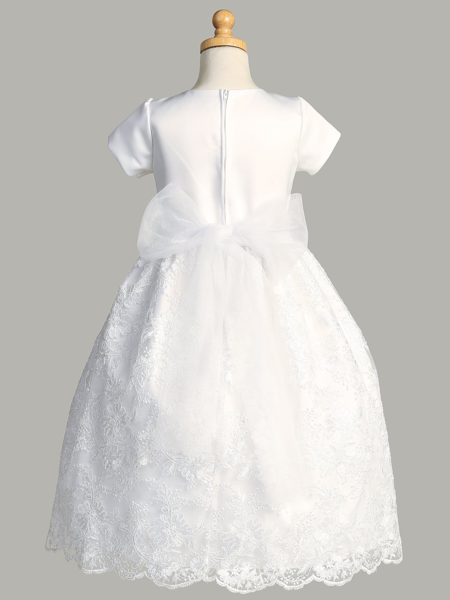 Close-up view of the satin bodice with unremovable pearls and rhinestones on the waistline of the First Communion Dress.