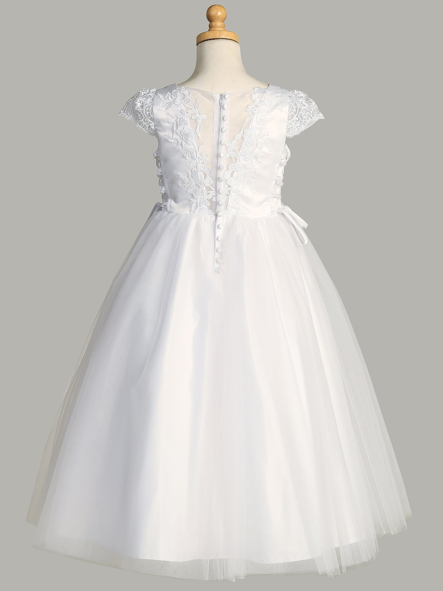 Side view of the First Communion Dress showing the corset sides and satin buttons.