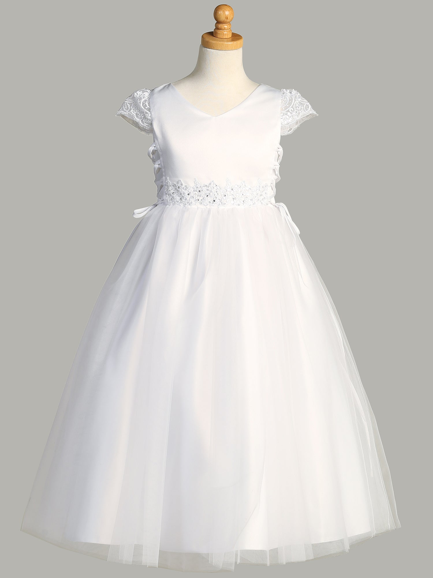 A full-length view of the First Communion Dress showing the tea-length and elegant silhouette.