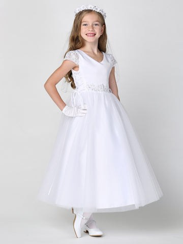 A girl wearing a graceful white First Communion Dress with a satin bodice and lace cap sleeves.