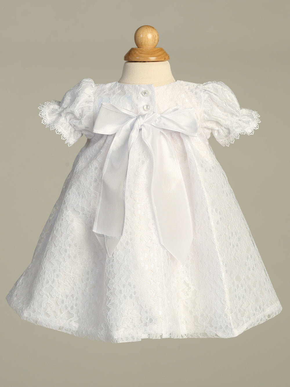 Melissa Baptism Dress - Girls' White Dress featuring lace fabric, puff sleeves, and a large satin bow, perfect for traditional baptisms.