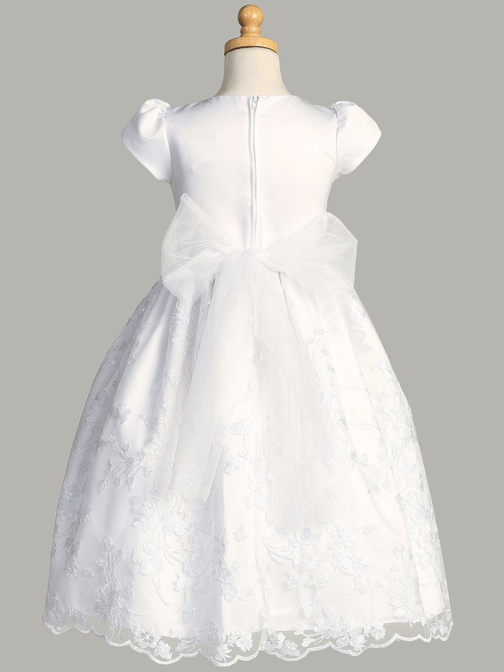 Close-up view of the satin bodice and embroidered tulle skirt with sequins on the First Communion Dress.
