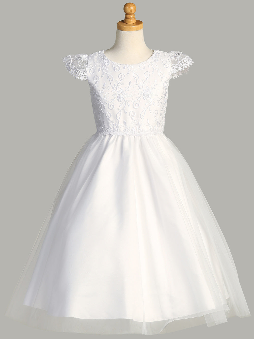 A full-length view of the First Communion Dress showing the tea-length and elegant tulle skirt.