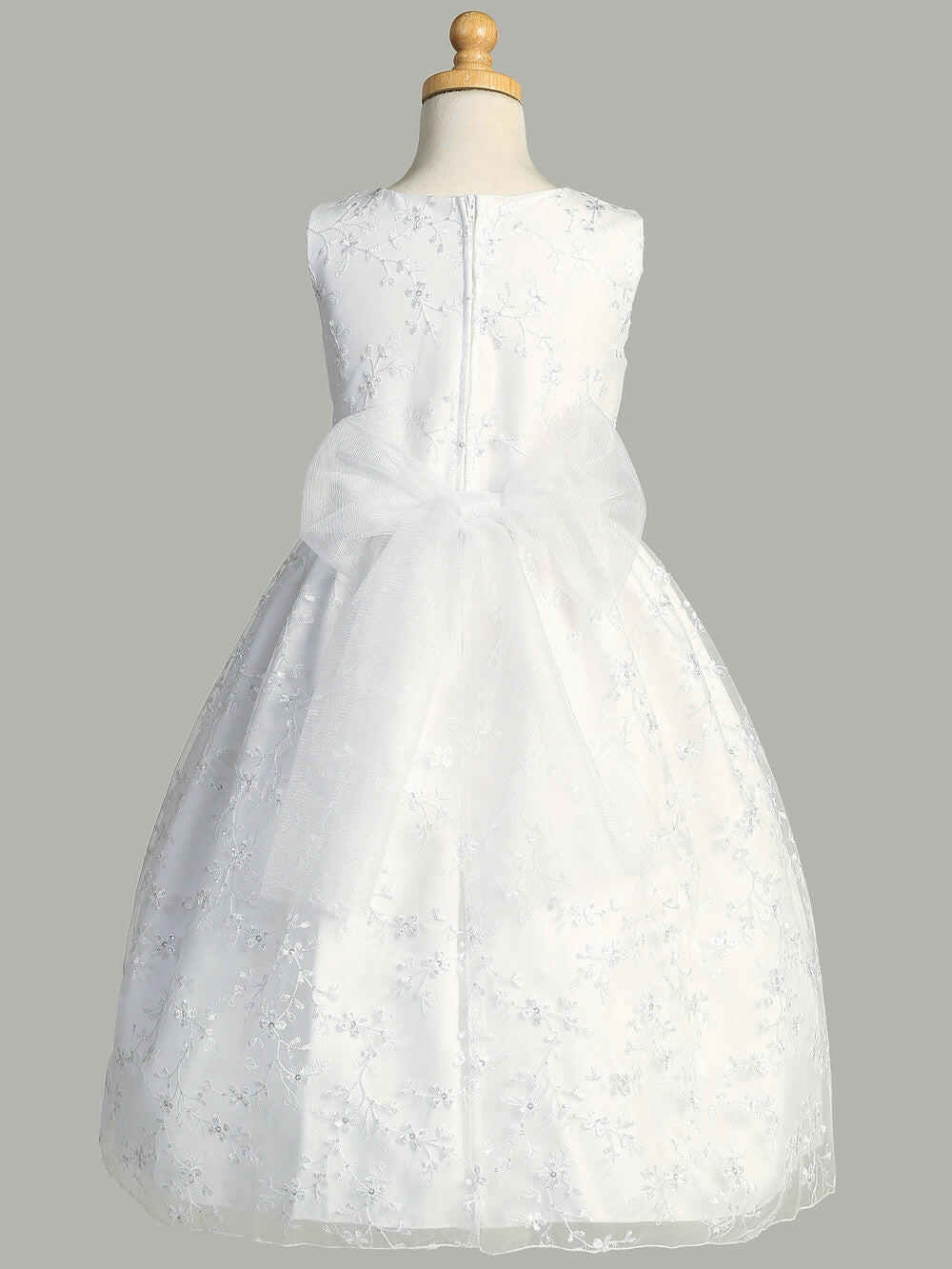 Back view of Girls' First Communion Dress with embroidered tulle, sequin accents, and large organza bow, tea-length design by Malcolm Royce.