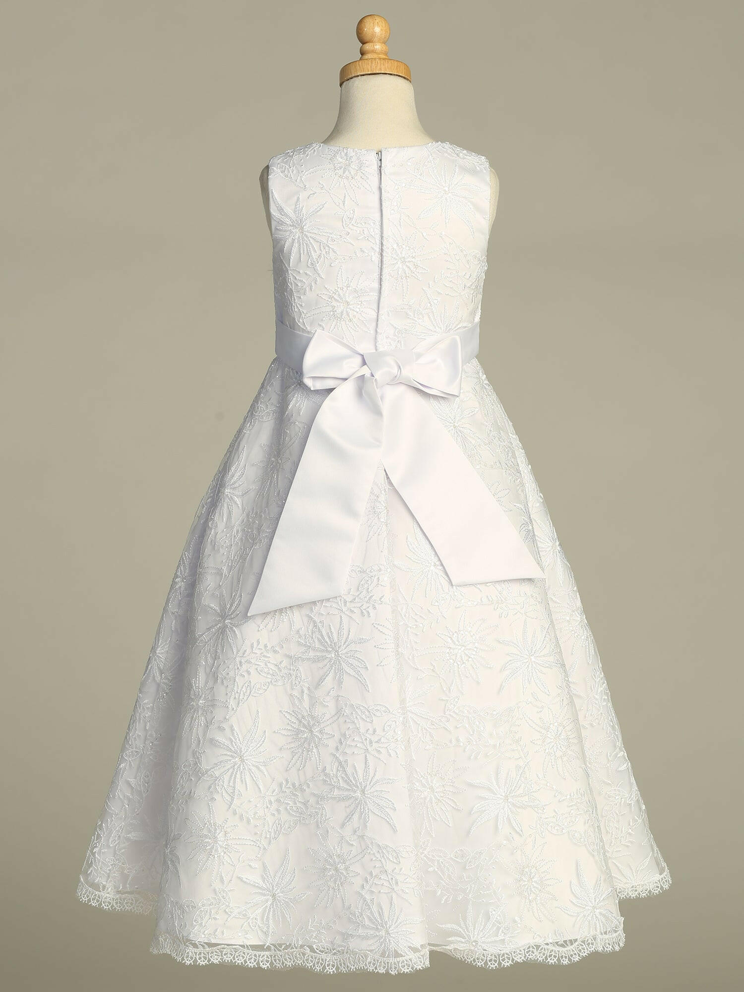 Close-up view of the embroidered tulle with sequins detailing on the skirt of the First Communion Dress.