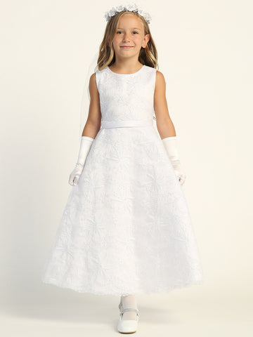 A girl wearing a stunning white First Communion Dress with embroidered tulle.