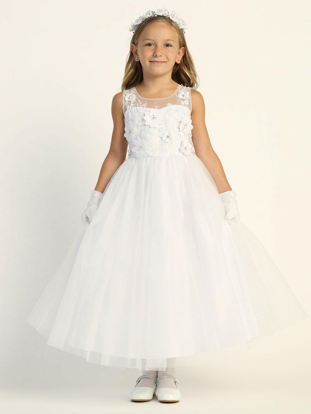 A girl wearing a beautiful white First Communion Dress with embroidered tulle and 3D flowers.