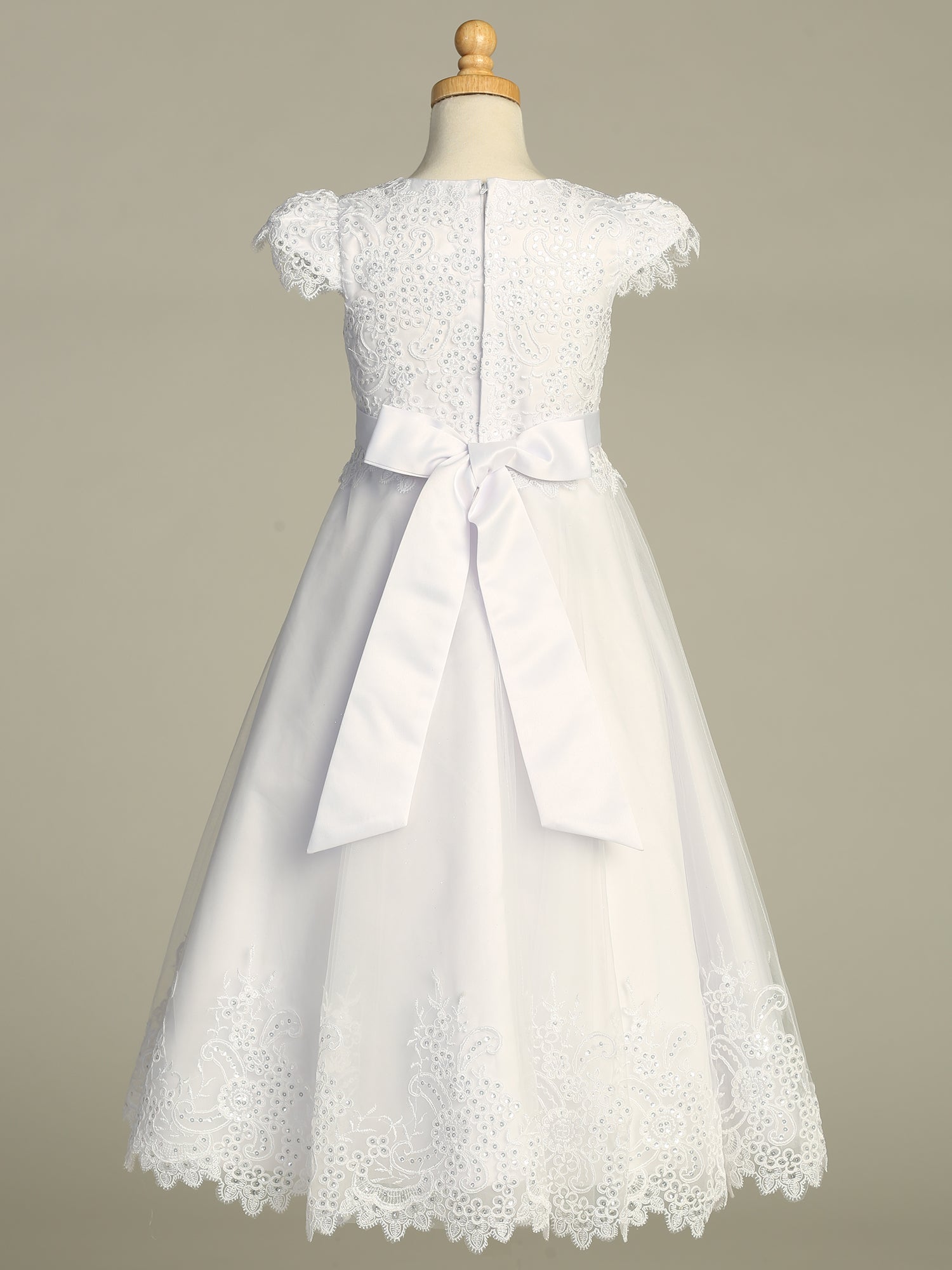 Close-up view of the embroidered tulle skirt adorned with sequins on the First Communion Dress.