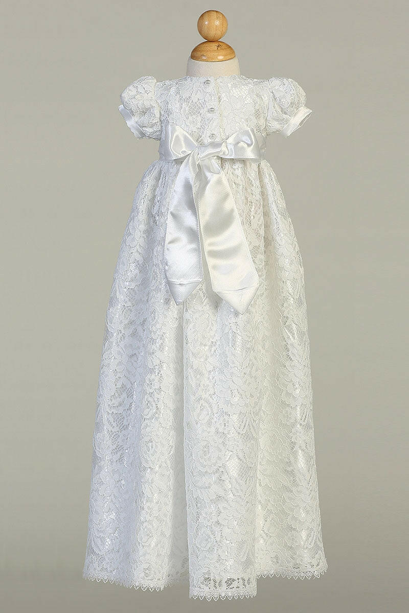 Back view of Suzana Baptism Dress for girls featuring satin bow and button closure. Elegant lace design for special occasions.