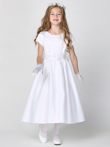 A girl wearing an elegant white satin First Communion Dress with silver corded trim on the waist.