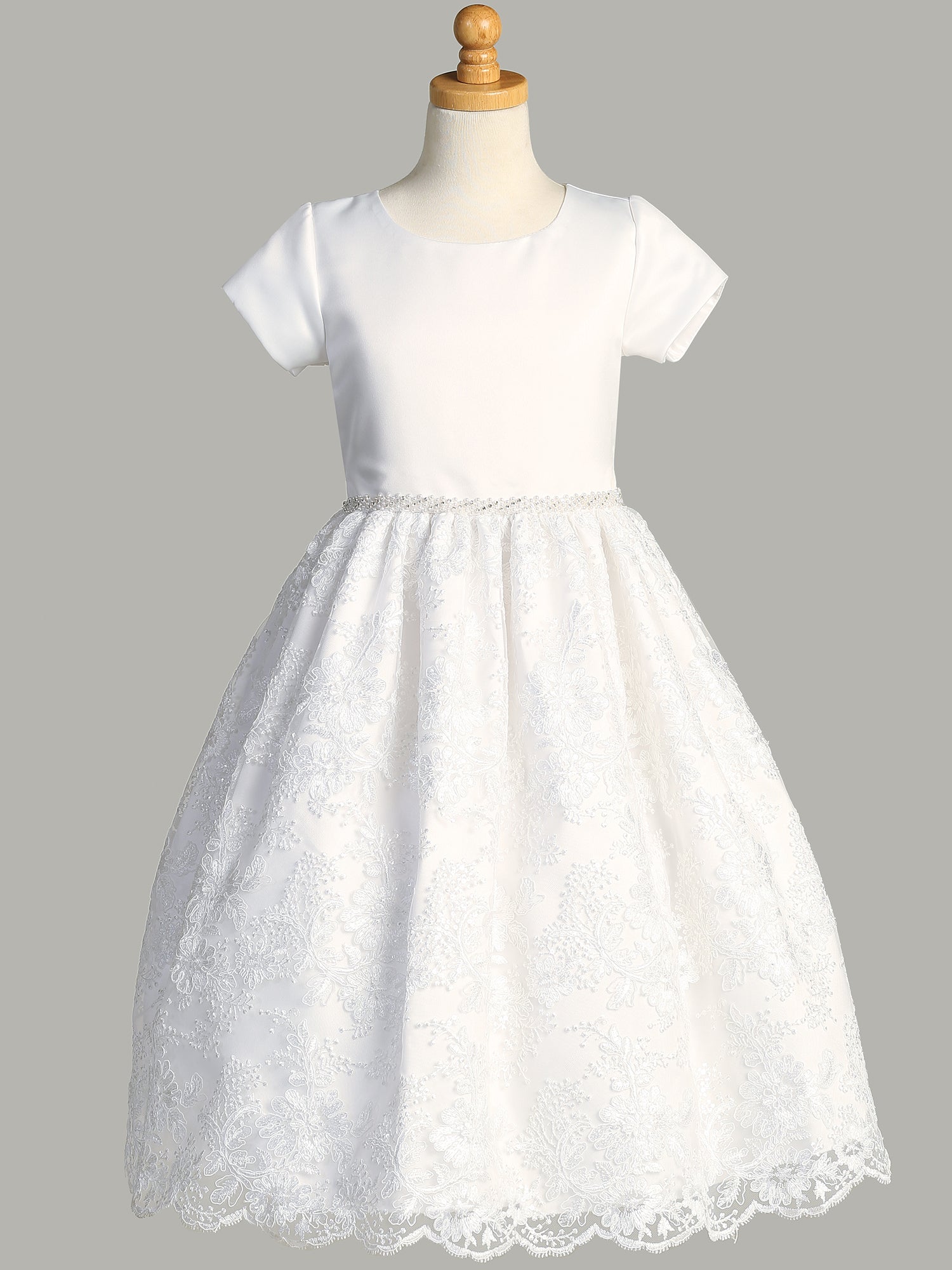 A side view of the First Communion Dress showing the short sleeves and the tea-length of the dress.