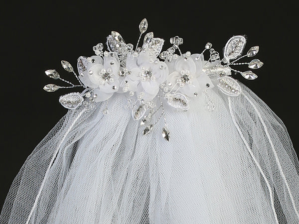 24" Communion veil with organza flowers, rhinestones, and crystals on a white headpiece, ideal for girls' religious ceremonies.