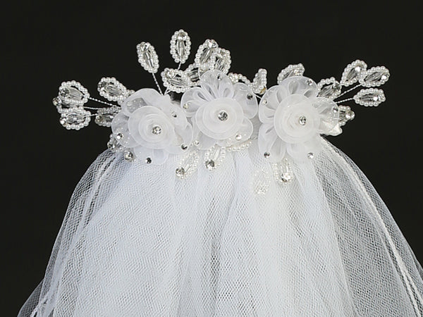 24" Communion veil with organza flowers, pearls, and crystal accents on a decorative headpiece. Ideal for girls' religious ceremonies.