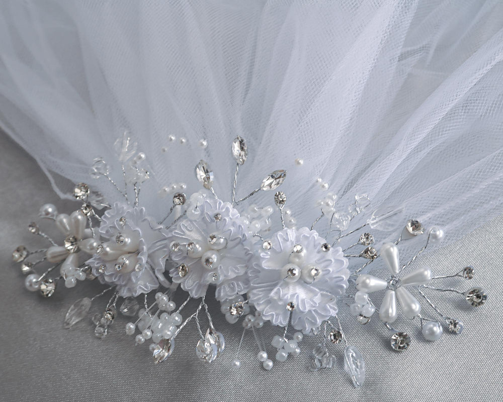 Detailed view of 24" veil headpiece featuring corded flowers, pearls, and rhinestones. Elegant accessory for First Communion attire.
