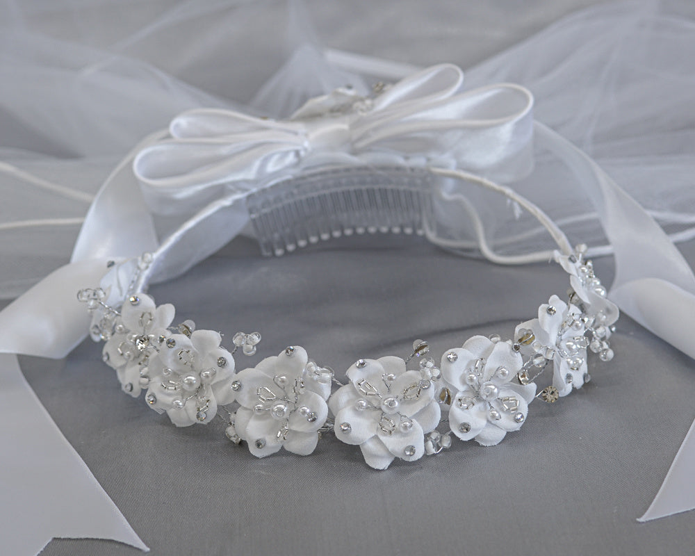 24" Communion veil with satin flowers, pearls, beads, and rhinestones, featuring a satin bow and comb for secure fit, ideal for girls' religious events.