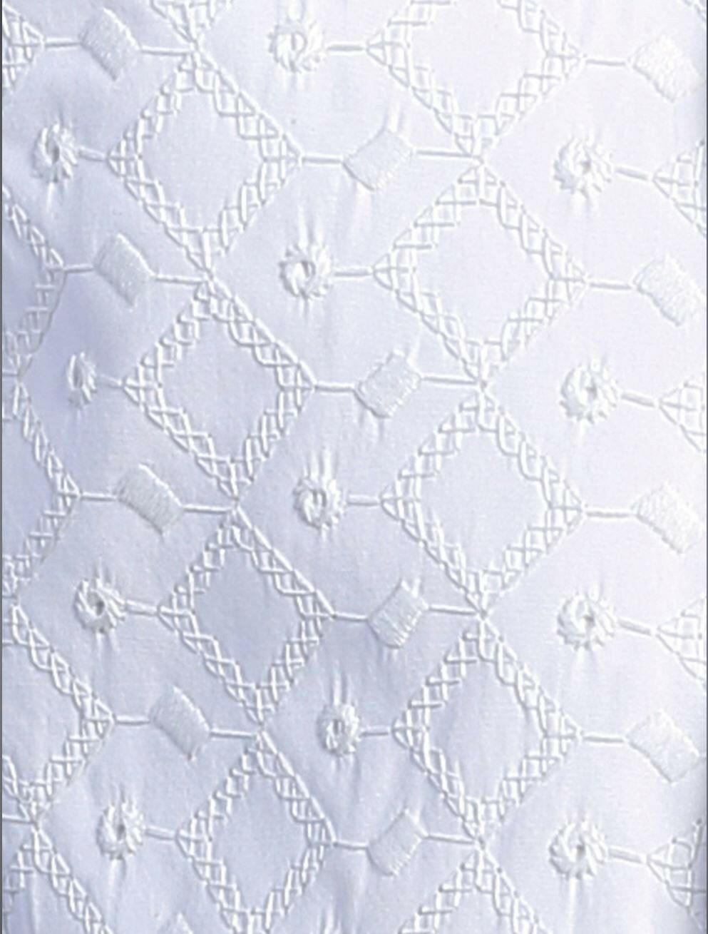 Close-up of Grayson white baptism romper fabric showing intricate embroidered diamond and floral patterns for a refined ceremonial look.