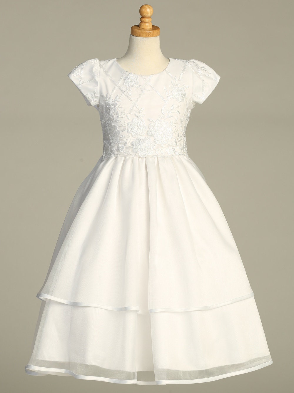 Back view of the First Communion Dress showing the zip fastening and bow tie.