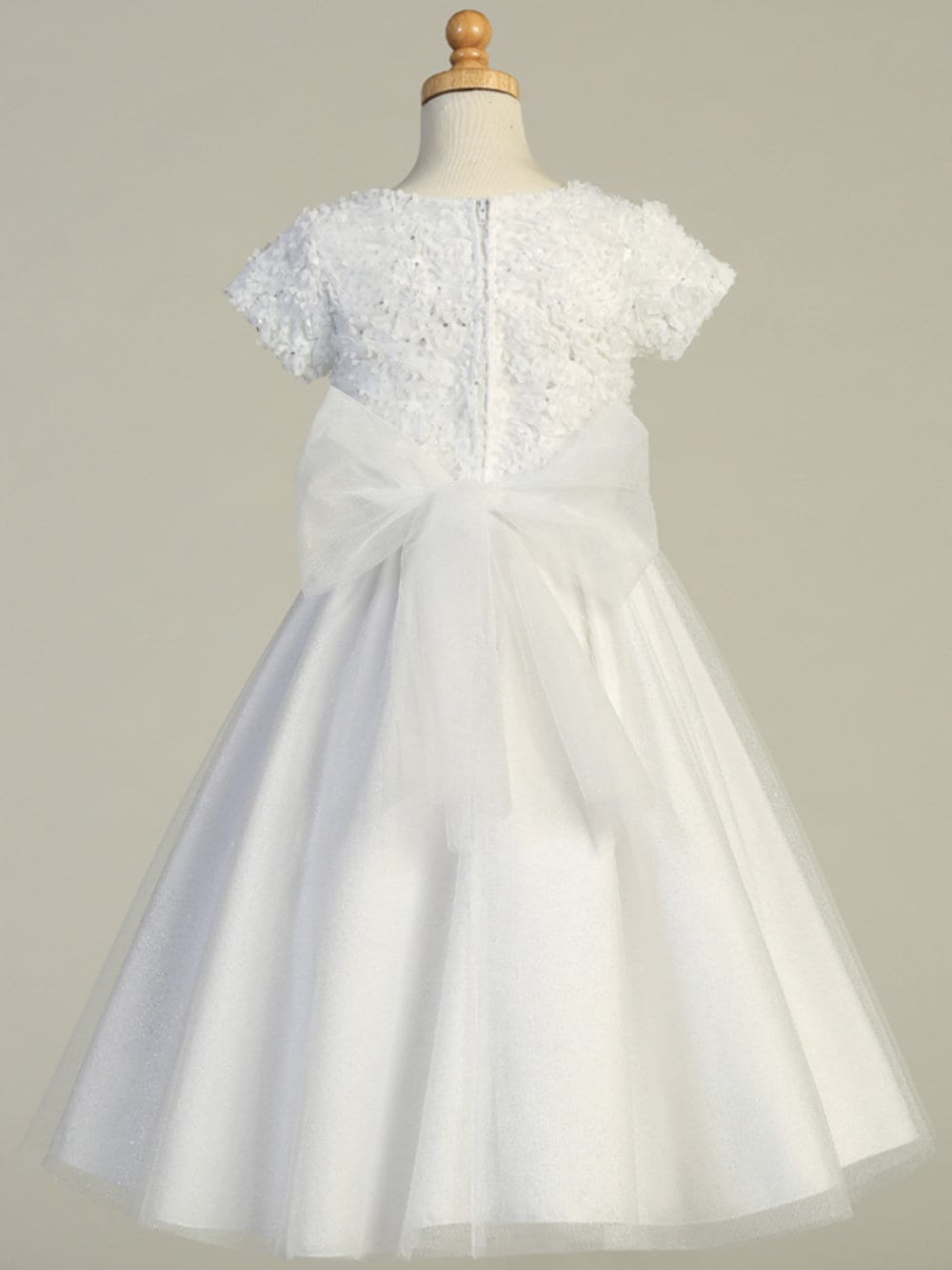 A view of the glitter tulle skirt with beads and sequins waist trim.