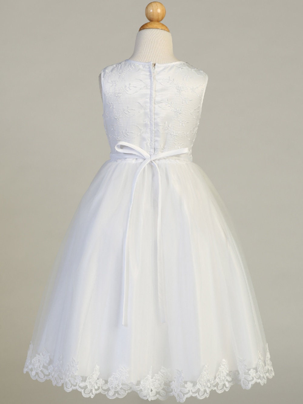 Close-up view of the embroidered tulle bodice with flower appliques at the neckline, showcasing the intricate details.