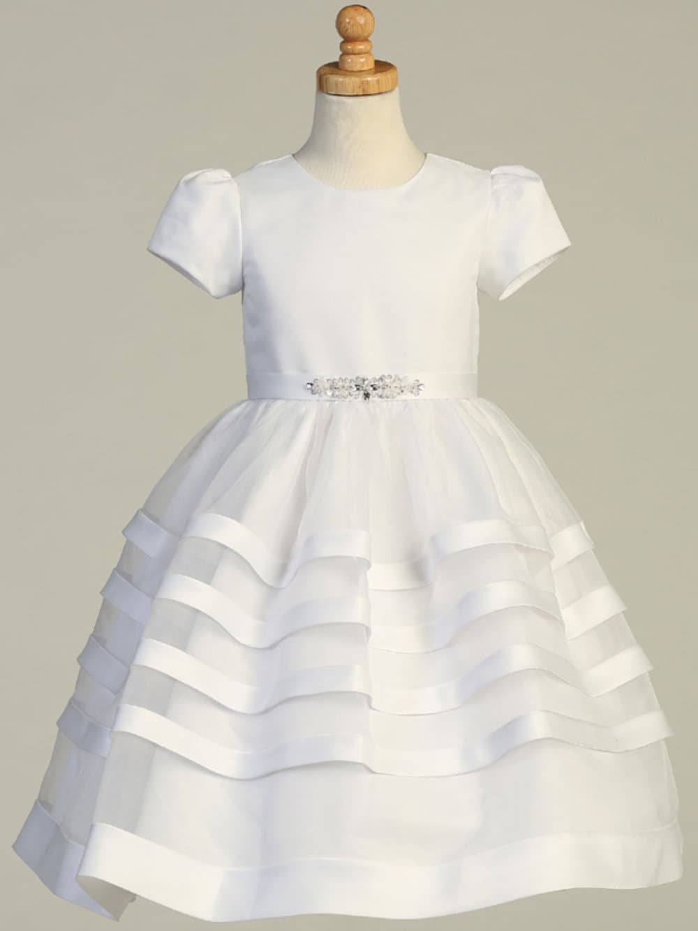 Front view of Girls' White First Communion Dress SP708 featuring satin bodice, jeweled waist detail, and layered organza tea-length skirt.